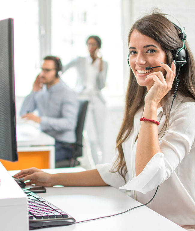 Image of a phone operator, smiling towards the viewer, representing contacting Mier Temporary Staffing